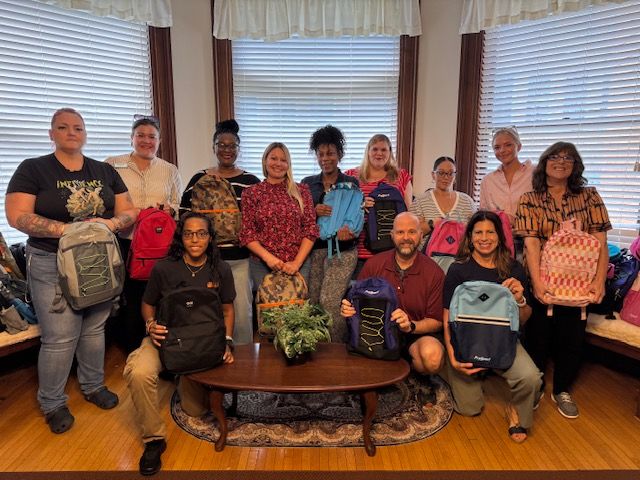 The STEL team with donated backpacks