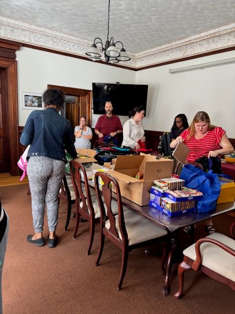 STEL staff packing backpacks for the community